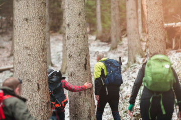 Man hiking in winter mountains with heavy backpack. Travel lifestyle wanderlust adventure winter vacations outdoor into the wild