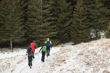 People hiking in beautiful winter mountains for winter sport activity snow mountain hills. Going for hikes in the winter for winter sports like winter hiking and cross-country skiing is very rewarding