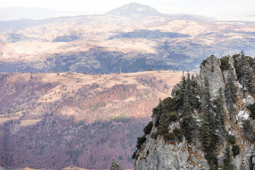 Fototapeta premium Piatra Craiului National Park, hiking above the clouds, near Piatra Mica or Cabana Curmatura. Piatra Craiului mountains are a mountain range in the Southern Carpathians. Bucegi Mountains on background