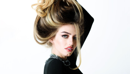 Beautiful girl with hair in hand. Hairstyle. Hairdresser. Fashion makeup. Jewelry. Beauty salon.