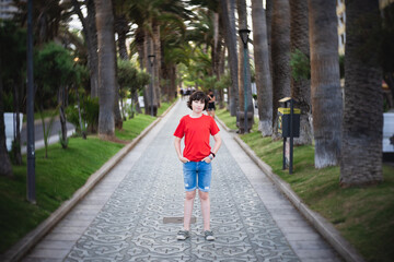 Portrait of a teenager on the famous palm avenue in Puerto de la Cruz. Tenerife. Canary Islands. Spain.