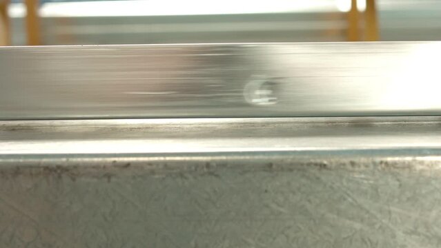 The profile passing in front of the camera in the factory where aluminum profiles are produced.