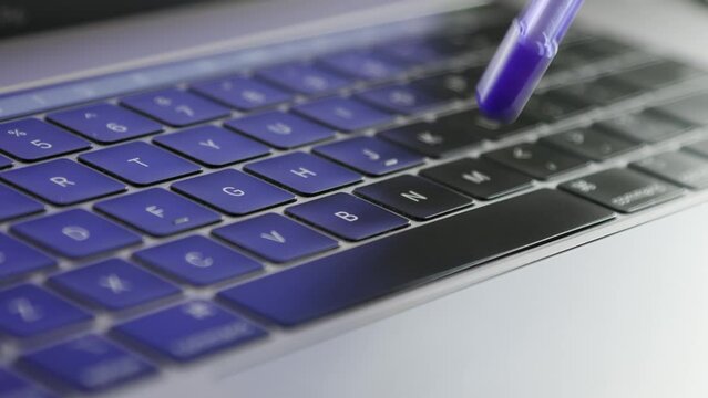 Typing with pencil on laptop keyboard., stop spreading the coronavirus