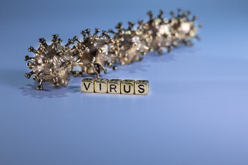 Strong angry virus with a face. The coronavirus is slightly blurred. A type of virus made of metal