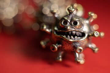 Strong angry virus with a face. The coronavirus is slightly blurred. A type of virus made of metal