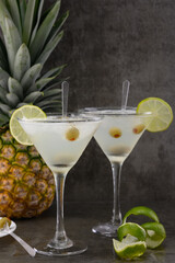 Margarita cocktail with olives and lemon on gray background