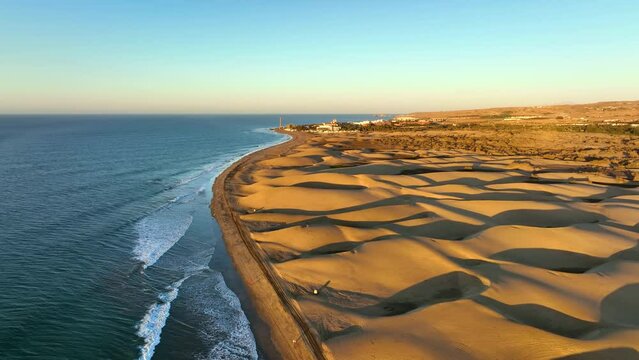 Sand dunes meet the Atlantic Ocean. Top view of Maspalomas sand dunes. Aerial view of Gran Canaria Island.