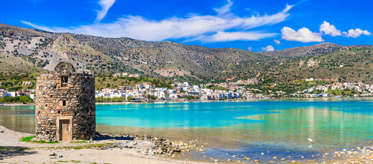 Picturesque scenery with old windmill and crystal waters in Elounda. Crete island , Greece