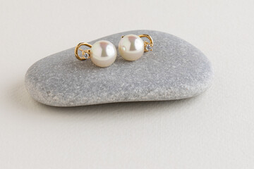 White pearls on a gray stone