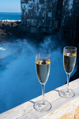 New year celebration with two glasses of champagne or Spanish cava sparkling wine and view on black lava rocks, Canary islands, winter tourists destination