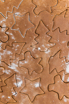 Preparing Christmas cutout gingerbread cookies