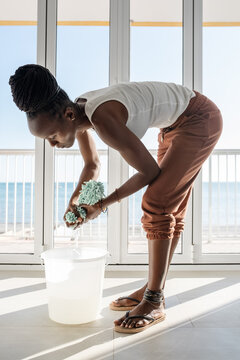African housewife wringing mop cloth
