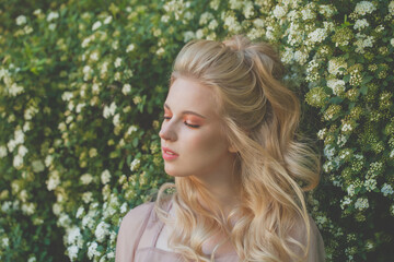 Naklejka premium Portrait of young spring blond woman with long wavy hairstyle. Back View