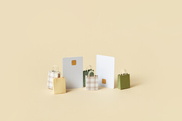 Credit cards and shopping bags over beige background