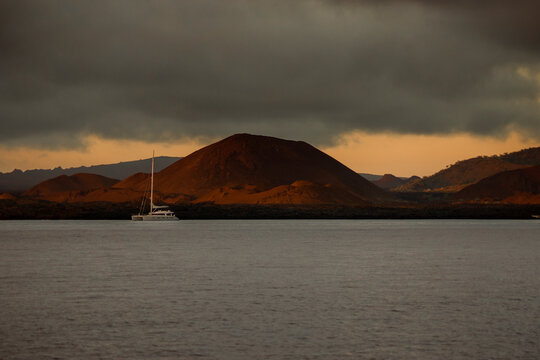 Boat anchored in front of Bartolom&eacute; Island, Galapagos, under a grey sky
