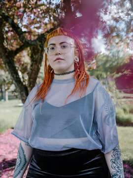 Girl redhead dreadlocks portrait in white flowers