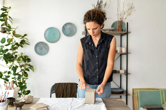 Woman Cutting Clay With String