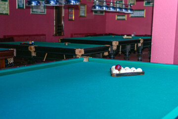 Billiard balls, cues in the billiard room close-up.