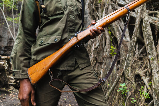 Unrecognizable man holding a weapon