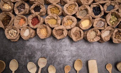 Big set of Indian spices and herbs. On a black board.