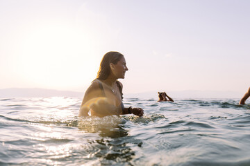 Friends having fun in the ocean on a sunny day 