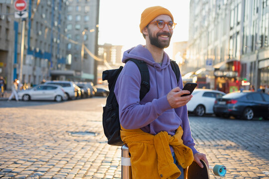 a man with a phone in his hands smiling
