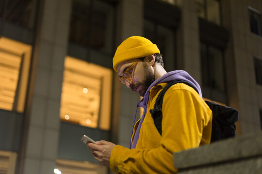 man in yellow clothes with phone
