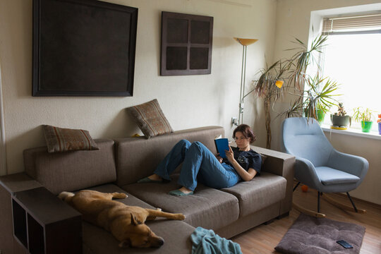girl reading a book on the couch
