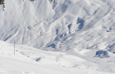 Fototapeta na wymiar Ski slopes of snow covered mountains in French alps 