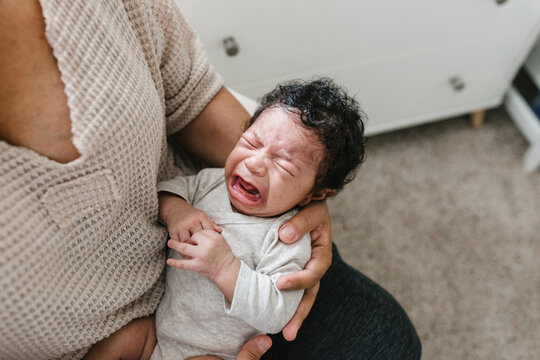 Newborn crying with mother