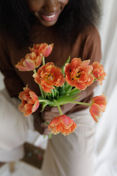 A black woman with fowers