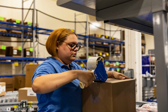 working packing shipping box at warehouse