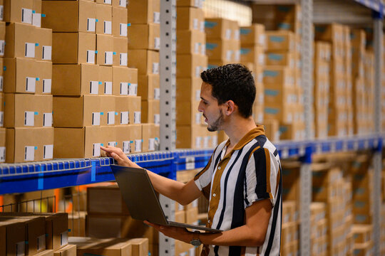 Warehouse worker reads bar codes on product 