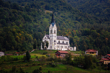 Fototapeta na wymiar San Fermin Church in the mountain village of Drežnica, beautiful panoramic view, Slovenia