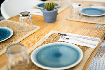 Table setting with dishware in restaurant