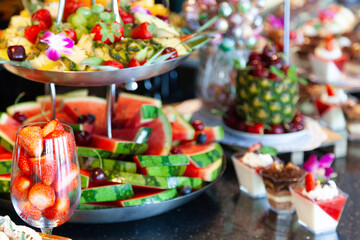 sweet buffet with confectionery bar, fruits, fresh healty sweets, craft dessert, coctail bar, friut tower pineapple, strawberries salad.