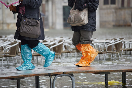 Gumboot plastic shoe covers - tourists walk path in Venice
