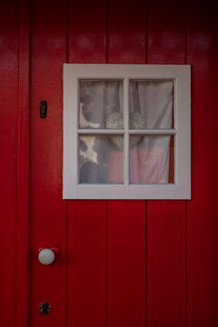 Tine window on the red door with heart decor