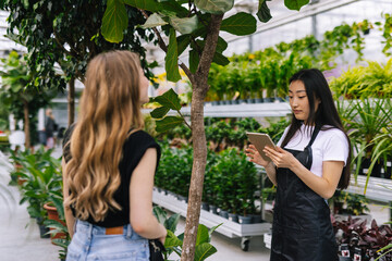 Worker using digital device in order to check price 