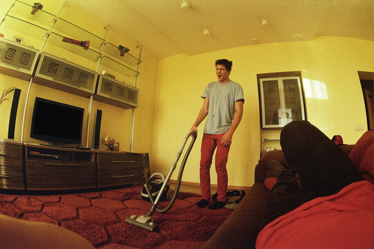 Man Vacuuming Carpet Suffering At Home