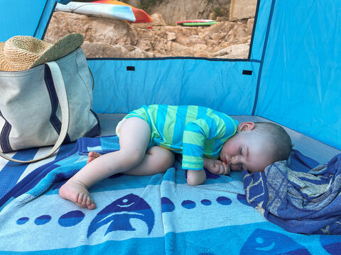 Baby Sleeping Outside Under the Shade of a Beach Tent