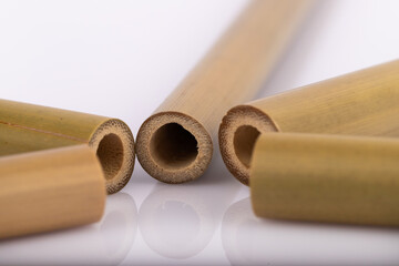 Bamboo straws on a white background. Ecological bamboo straws. Thanks to these bamboo straws, we can be a more environmentally conscious society. Say no to plastic.