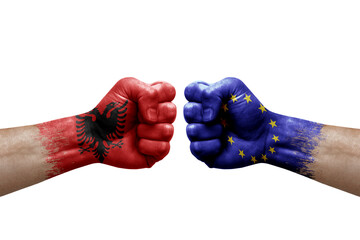 Two hands punch to each others on white background. Country flags painted fists, conflict crisis concept between albania and european union