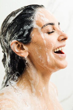 Woman taking a shower with soap