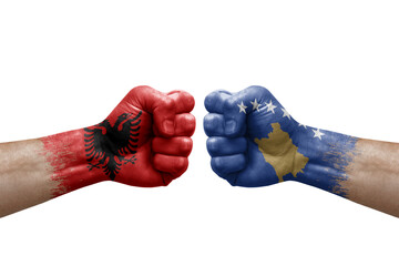 Two hands punch to each others on white background. Country flags painted fists, conflict crisis concept between albania and kosovo - obrazy, fototapety, plakaty