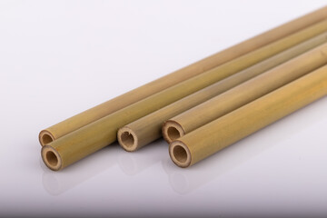 Bamboo straws on a white background. Ecological bamboo straws. Thanks to these bamboo straws, we can be a more environmentally conscious society. Say no to plastic.