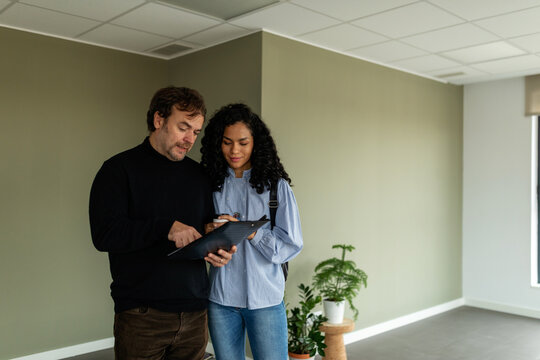 Real estate agent reading rental contract to tenant