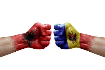 Two hands punch to each others on white background. Country flags painted fists, conflict crisis concept between albania and moldova