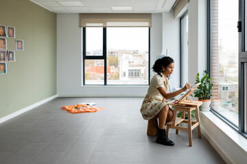 Female artist painting picture at studio