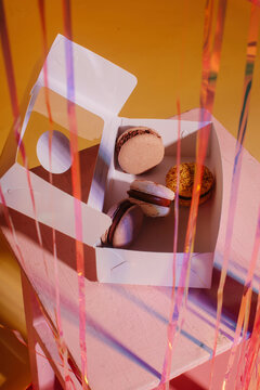 Box with macaroons on stool
